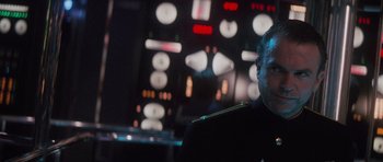 Movie still from “The Hunt for Red October” (1990), directed by John McTiernan – A man sitting in front of a large screen; Close Up shot, Over the shoulder angle