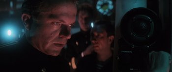 Movie still from “The Hunt for Red October” (1990), directed by John McTiernan – A group of men standing next to each other in the dark; Close Up shot, Over the shoulder angle