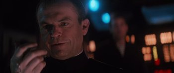 Movie still from “The Hunt for Red October” (1990), directed by John McTiernan – A person wearing a suit and tie; Close Up shot, Over the shoulder angle