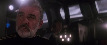 Movie still from “The Hunt for Red October” (1990), directed by John McTiernan – An older man's face in the dark; Close Up shot, Over the shoulder angle