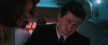 Movie still from “The Hunt for Red October” (1990), directed by John McTiernan – A person wearing a suit and tie; Close Up shot, Over the shoulder angle