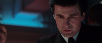 Movie still from “The Hunt for Red October” (1990), directed by John McTiernan – A person wearing a suit and tie; Close Up shot, Low angle