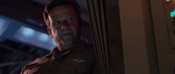 Movie still from “The Hunt for Red October” (1990), directed by John McTiernan – A person in a uniform looking at a mirror; Close Up shot, Low angle