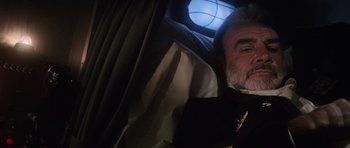 Movie still from “The Hunt for Red October” (1990), directed by John McTiernan – An older man sitting in a car with a window open; Close Up shot, Overhead angle