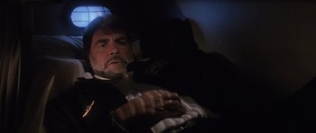 Movie still from “The Hunt for Red October” (1990), directed by John McTiernan – A person sitting in a car; Medium shot, Overhead angle