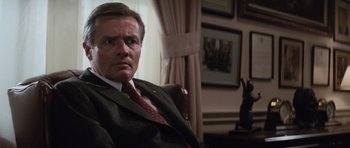 Movie still from “The Hunt for Red October” (1990), directed by John McTiernan – A person wearing a suit and tie; Close Up shot, Low angle