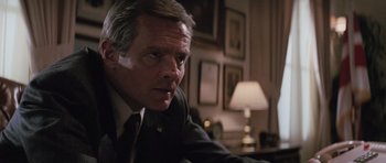 Movie still from “The Hunt for Red October” (1990), directed by John McTiernan – A person wearing a suit and tie; Close Up shot, Low angle