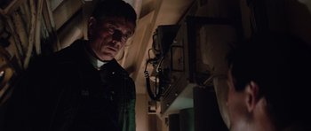 Movie still from “The Hunt for Red October” (1990), directed by John McTiernan – A man standing next to a wall in the dark; Close Up shot, Low angle