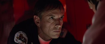 Movie still from “The Hunt for Red October” (1990), directed by John McTiernan – A person with a flag on his shirt; Close Up shot, Low angle