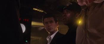 Movie still from “The Hunt for Red October” (1990), directed by John McTiernan – Two men standing next to each other in a dark room; Close Up shot, Low angle