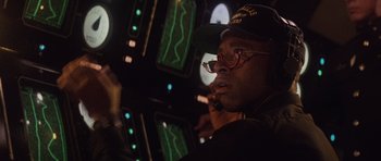 Movie still from “The Hunt for Red October” (1990), directed by John McTiernan – A man in a black hat and glasses smoking a cigarette; Close Up shot, Low angle