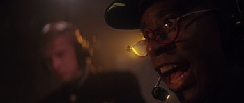 Movie still from “The Hunt for Red October” (1990), directed by John McTiernan – A person wearing glasses and a hat; Extreme Close Up shot, Low angle