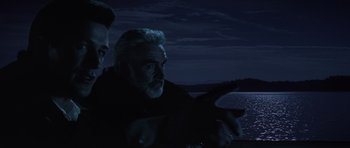 Movie still from “The Hunt for Red October” (1990), directed by John McTiernan – A man pointing at something while another man looks at him; Close Up shot, Over the shoulder angle