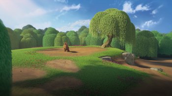 Movie still from “The Ice Age Adventures of Buck Wild” (2022), directed by John C. Donkin – A bear sitting in the middle of a grassy field next to trees; Extreme Wide shot, Low angle