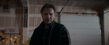 Movie still from “The Ice Road” (2021), directed by Jonathan Hensleigh – A person wearing a jacket in a room; Close Up shot, Low angle