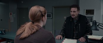 Movie still from “The Ice Road” (2021), directed by Jonathan Hensleigh – A man and a woman sitting at a table talking to each other; Medium shot, Over the shoulder angle