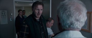 Movie still from “The Ice Road” (2021), directed by Jonathan Hensleigh – A man standing next to another man in front of another man; Medium shot, Over the shoulder angle