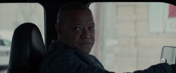 Movie still from “The Ice Road” (2021), directed by Jonathan Hensleigh – A man sitting in a car looking out the window; Close Up shot, Over the shoulder angle