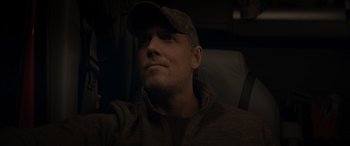 Movie still from “The Ice Road” (2021), directed by Jonathan Hensleigh – A person wearing a hat; Close Up shot, Low angle