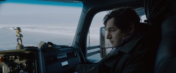 Movie still from “The Ice Road” (2021), directed by Jonathan Hensleigh – A man sitting in the driver's seat of a vehicle; Close Up shot, Over the shoulder angle