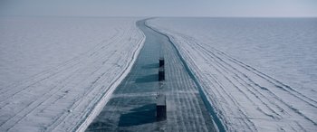 Movie still from “The Ice Road” (2021), directed by Jonathan Hensleigh – A road that has been cut into the middle of a frozen lake; Extreme Wide shot, Overhead angle