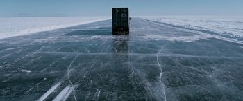 Movie still from “The Ice Road” (2021), directed by Jonathan Hensleigh – A semi truck driving on a frozen lake; Extreme Wide shot, High angle