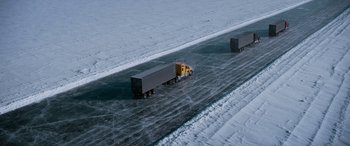 Movie still from “The Ice Road” (2021), directed by Jonathan Hensleigh – Two semi trucks driving down a frozen road; Extreme Wide shot, High angle