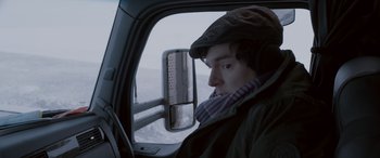 Movie still from “The Ice Road” (2021), directed by Jonathan Hensleigh – A man sitting in the driver's seat of a truck; Close Up shot, Over the shoulder angle