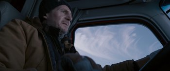 Movie still from “The Ice Road” (2021), directed by Jonathan Hensleigh – A man and a dog in a vehicle; Close Up shot, Low angle