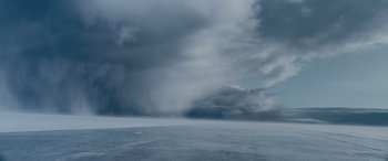 Movie still from “The Ice Road” (2021), directed by Jonathan Hensleigh – A cloudy sky over a large expanse of water; Extreme Wide shot, Low angle