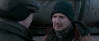 Movie still from “The Ice Road” (2021), directed by Jonathan Hensleigh – A person wearing a hat and a jacket; Close Up shot, Over the shoulder angle