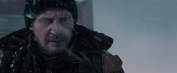 Movie still from “The Ice Road” (2021), directed by Jonathan Hensleigh – A person wearing a jacket and hat; Close Up shot, Low angle