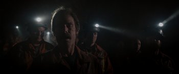 Movie still from “The Ice Road” (2021), directed by Jonathan Hensleigh – A man with a flashlight on his head; Close Up shot, Low angle