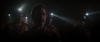 Movie still from “The Ice Road” (2021), directed by Jonathan Hensleigh – A man with a head lamp is standing next to another man in the dark; Close Up shot, Low angle