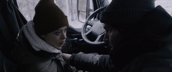 Movie still from “The Ice Road” (2021), directed by Jonathan Hensleigh – A woman is sitting in the driver's seat of a truck; Close Up shot, Over the shoulder angle