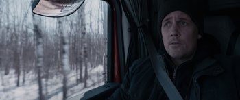 Movie still from “The Ice Road” (2021), directed by Jonathan Hensleigh – A man sitting in the driver's seat of a truck; Close Up shot, Low angle