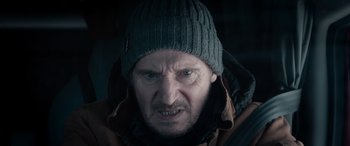 Movie still from “The Ice Road” (2021), directed by Jonathan Hensleigh – A person wearing a jacket and a hat; Close Up shot, Low angle