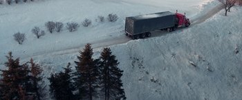 Movie still from “The Ice Road” (2021), directed by Jonathan Hensleigh – A truck driving down a snow covered road; Extreme Wide shot, Overhead angle