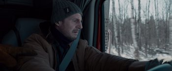 Movie still from “The Ice Road” (2021), directed by Jonathan Hensleigh – A man sitting in the driver's seat of a bus; Close Up shot, Over the shoulder angle