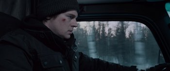 Movie still from “The Ice Road” (2021), directed by Jonathan Hensleigh – A man in a car looking out of the window; Close Up shot, Over the shoulder angle