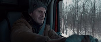 Movie still from “The Ice Road” (2021), directed by Jonathan Hensleigh – A man driving a truck in the snow; Close Up shot, Over the shoulder angle
