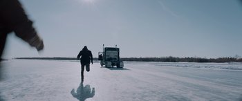 Movie still from “The Ice Road” (2021), directed by Jonathan Hensleigh – A man running across a snow covered field; Extreme Wide shot, Low angle