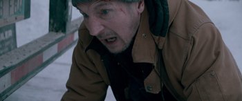 Movie still from “The Ice Road” (2021), directed by Jonathan Hensleigh – A person wearing a jacket and a hat; Close Up shot, High angle