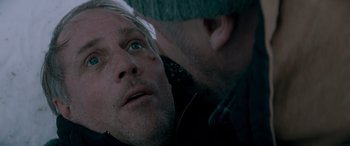 Movie still from “The Ice Road” (2021), directed by Jonathan Hensleigh – A man with blue eyes is looking at another man with blue eyes; Close Up shot, Over the shoulder angle