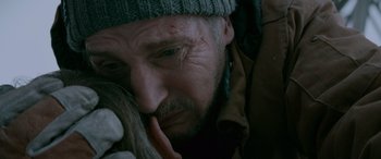 Movie still from “The Ice Road” (2021), directed by Jonathan Hensleigh – A person wearing a hat; Close Up shot, High angle