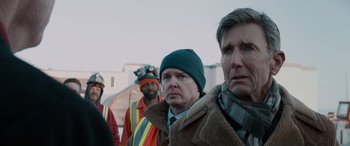 Movie still from “The Ice Road” (2021), directed by Jonathan Hensleigh – A group of men standing next to each other; Close Up shot, Over the shoulder angle