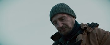 Movie still from “The Ice Road” (2021), directed by Jonathan Hensleigh – A person wearing a jacket and a hat; Close Up shot, Low angle