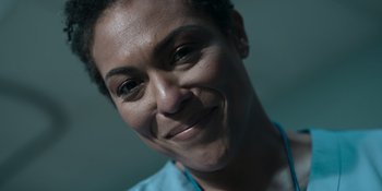 Movie still from “The In Between” (2022), directed by Arie Posin – A person smiling for the camera; Close Up shot, Low angle