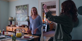 Movie still from “The In Between” (2022), directed by Arie Posin – Two women standing at a table in front of a stove; Medium shot, Over the shoulder angle