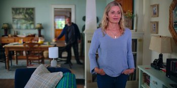 Movie still from “The In Between” (2022), directed by Arie Posin – A woman standing in front of a man in a living room; Medium shot, Over the shoulder angle